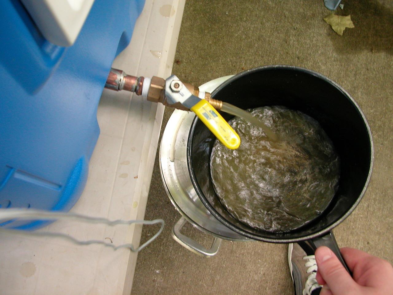 Recirculating the first couple quarts of wort before draining the cooler into the brew pot.