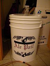 The primary fermentation bucket sitting in my closet with 5 gallons of wort becoming beer.