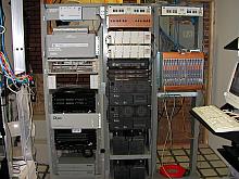 The telephone company's (clec) equipment racks.  The top left half has our fiber mux, the middle and right racks are the CopperCom phone switch.
